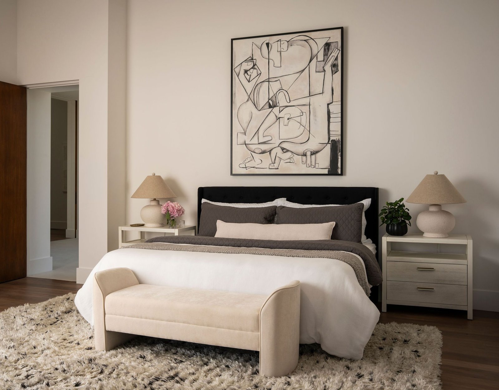 Bedroom with a black bed frame and art