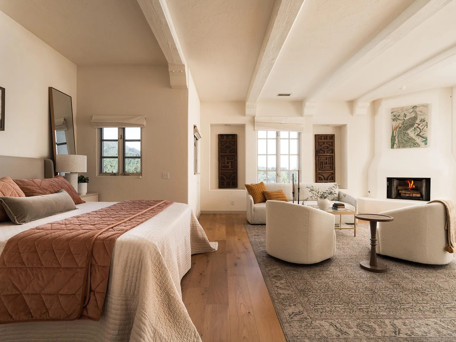 Bedroom with a terracotta quilt and a sitting area