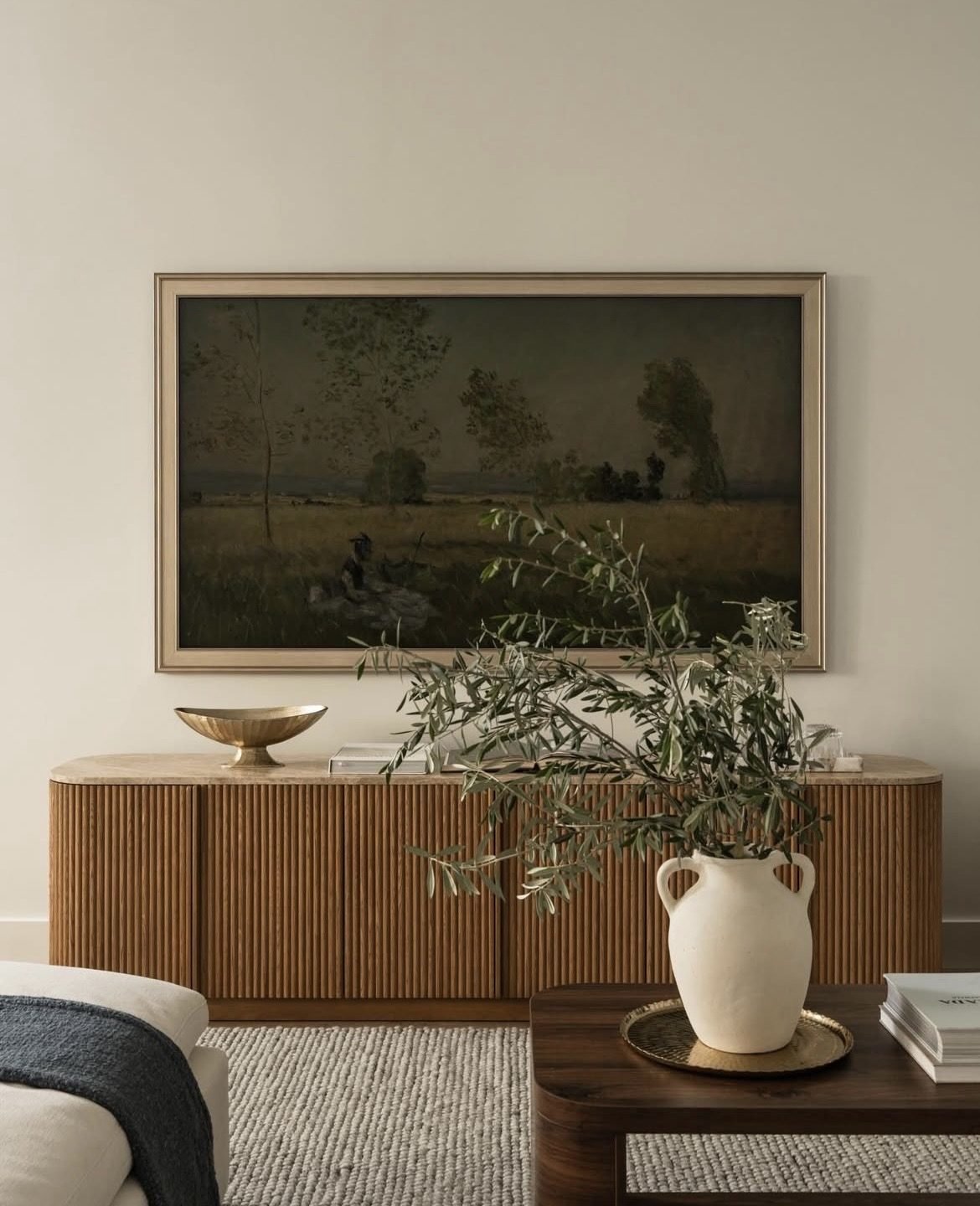 Styled credenza vignette with an olive branch and vase