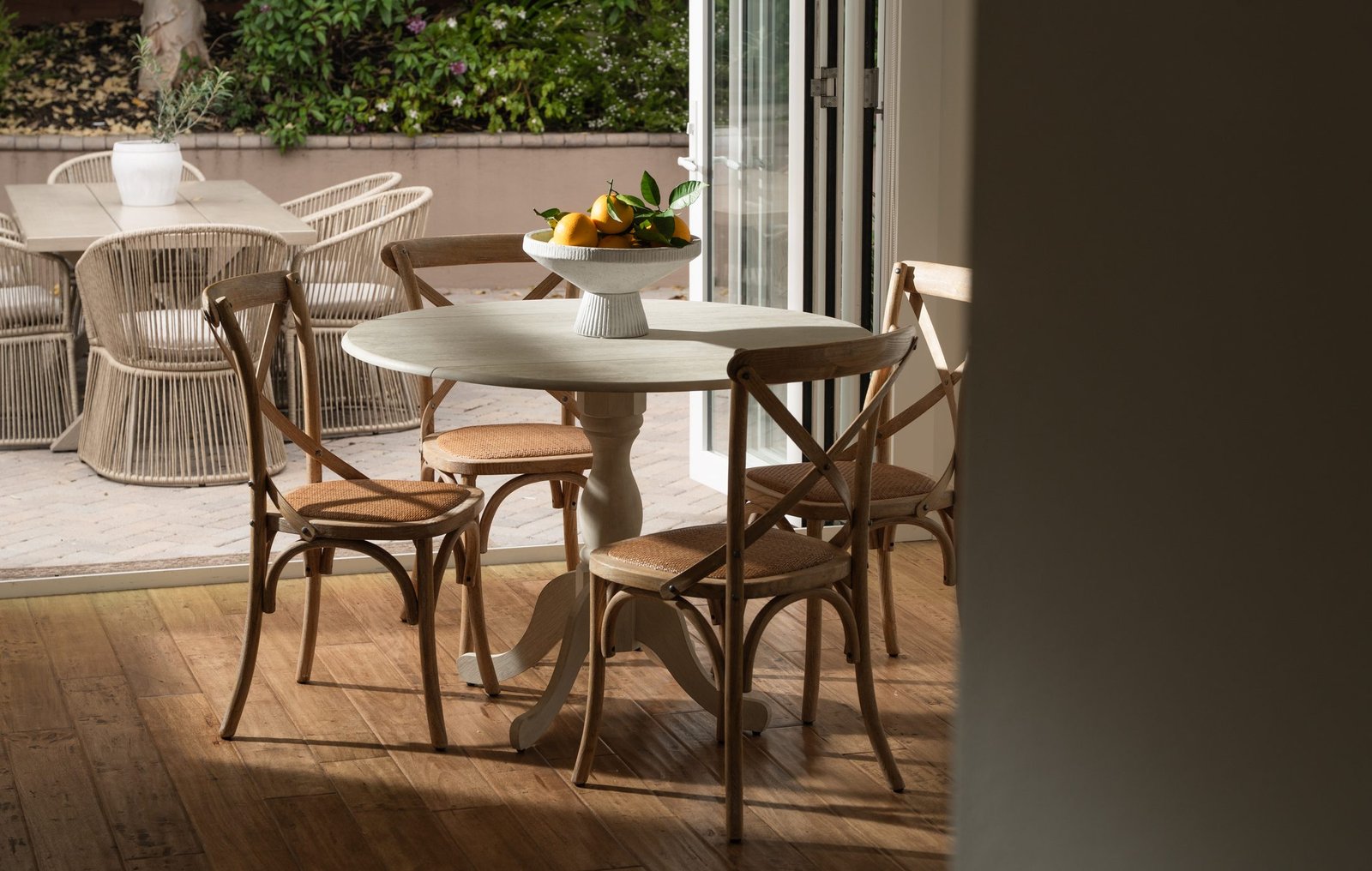 Moody dining room with a round table and bentwood chairs
