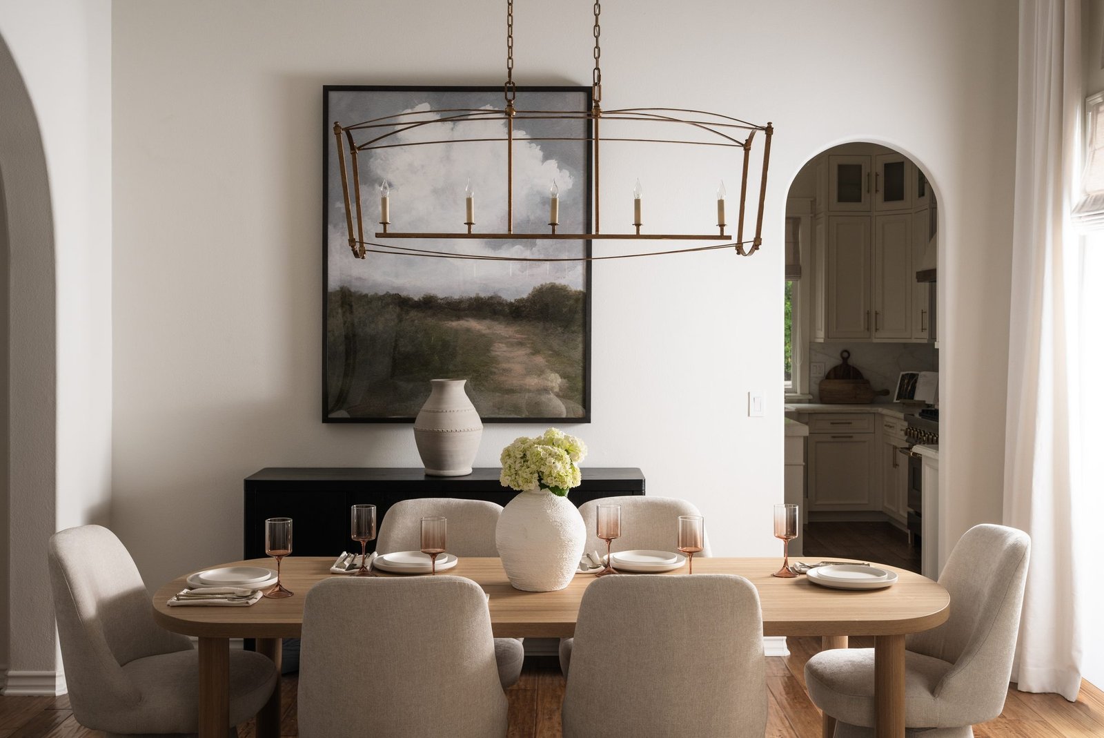 Warm dining room with a wood table and organic-coastal styling by S & S Interiors