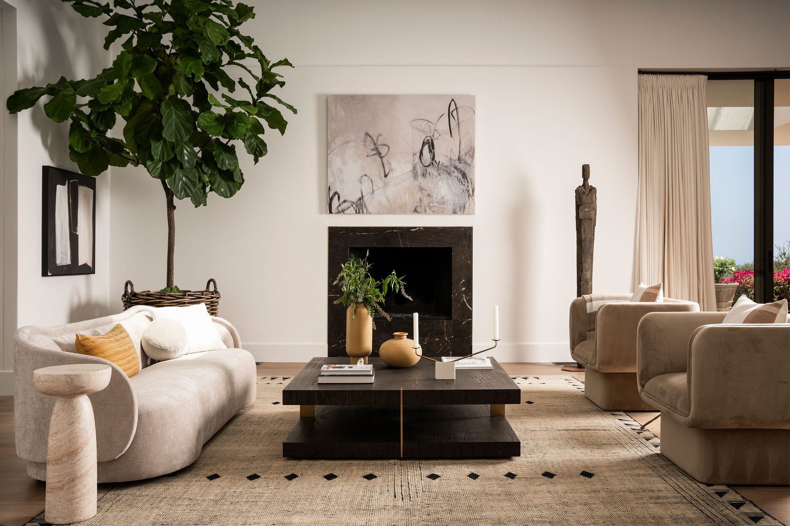 Neutral living room with a fig tree and fireplace