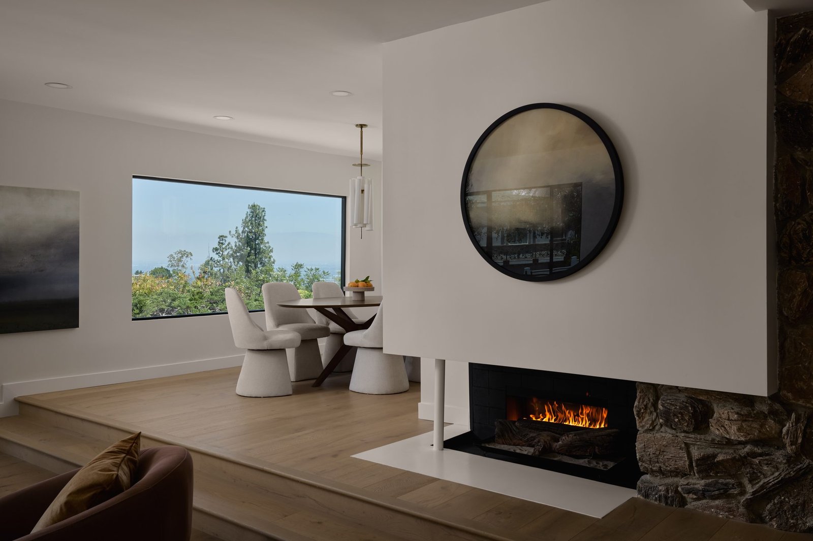Hillside living room with a modern fireplace and curved seating