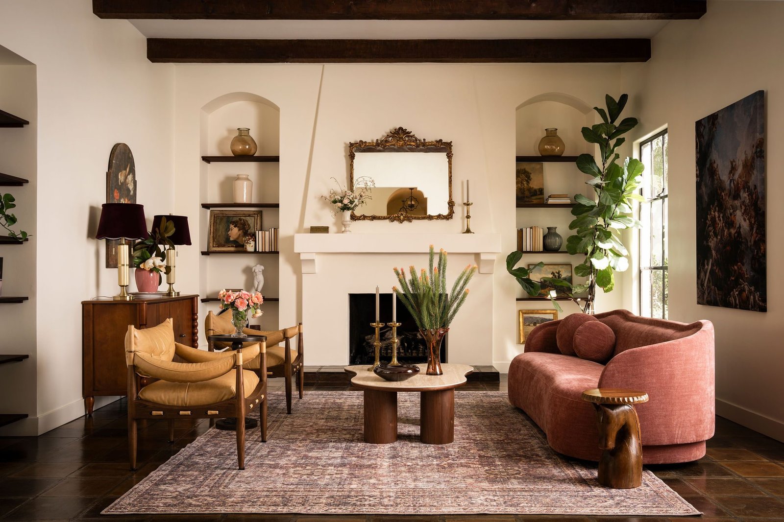 Eclectic living room with a pink sofa and fireplace