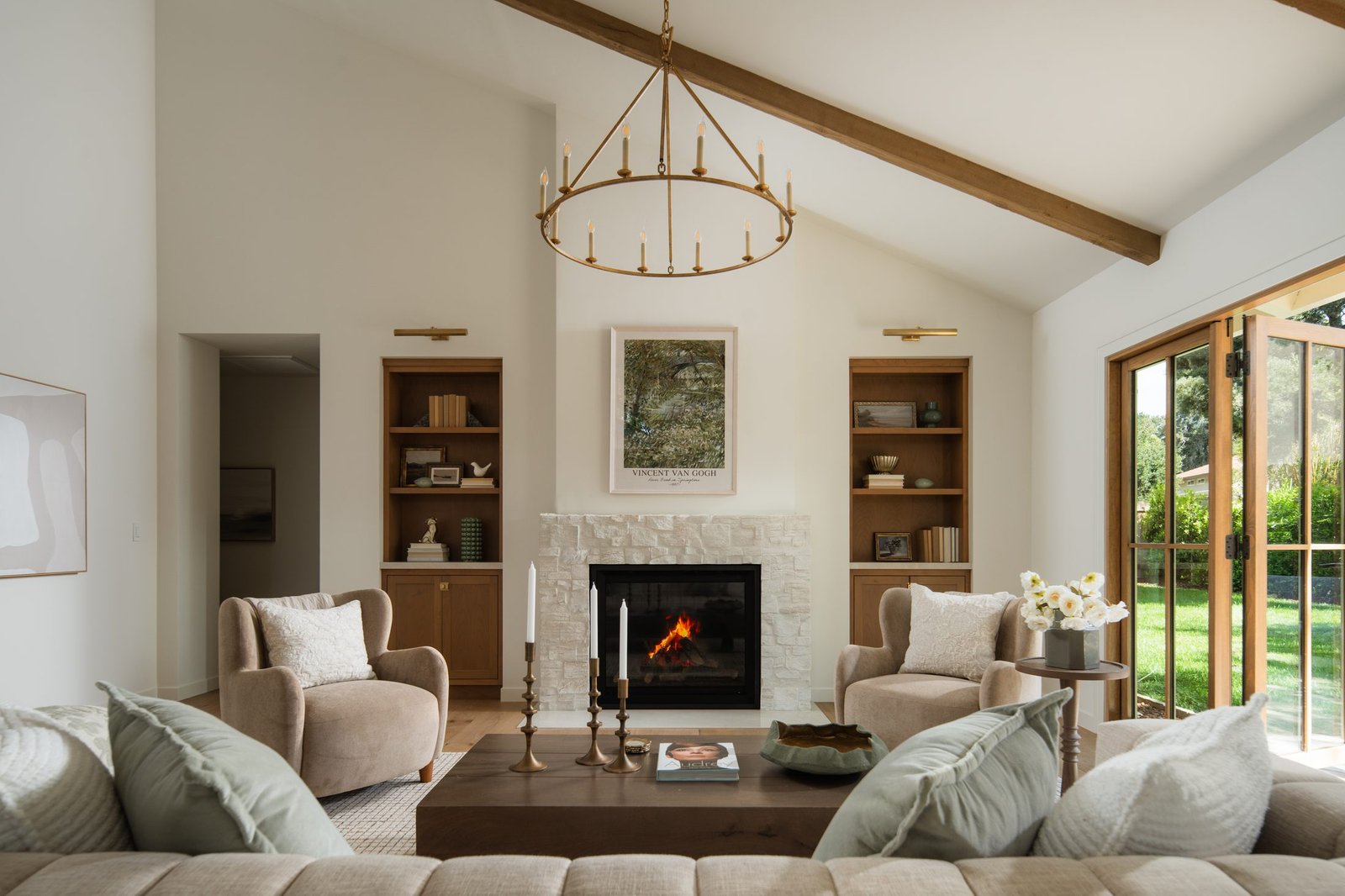 Living room with a vaulted beam ceiling and fireplace